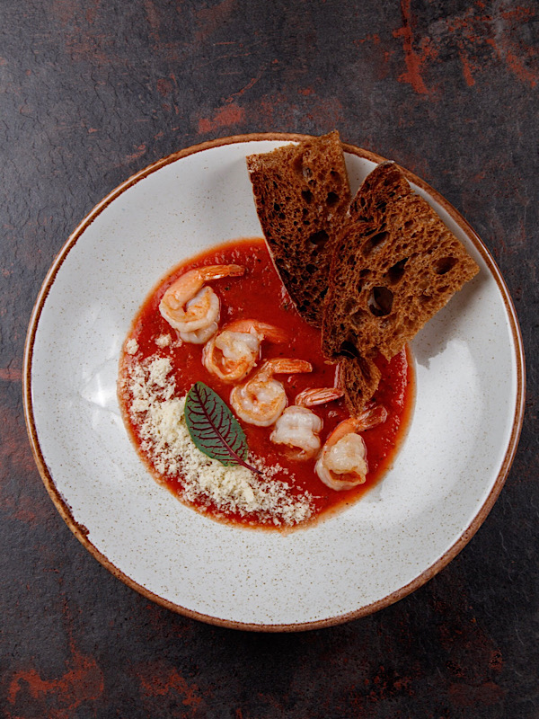 Bowl of velvety cream soup garnished with thyme