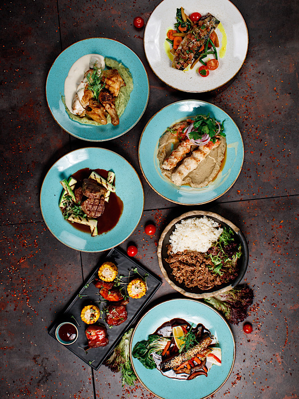 A spread of plated dishes prepared during a cooking workshop
